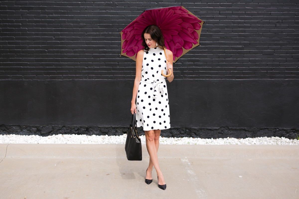 The Miller Affect wearing a belted midi dress in a polka dot print