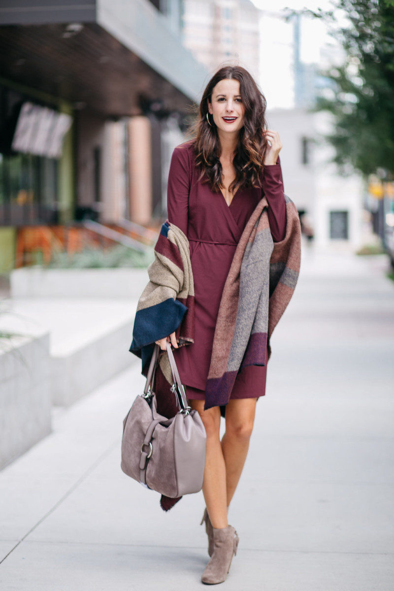 The Miller Affect wearing a burgundy dress for work and taupe suede wedge booties