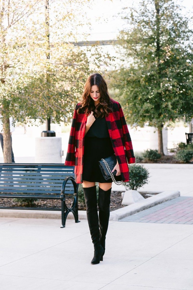 The Miller Affect wearing a buffalo plaid jacket with black Stuart Weitzman All Legs over the knee boots