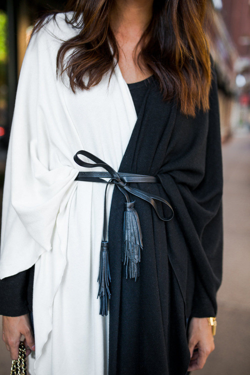 The Miller Affect wearing a black and white cape with a black tassel belt