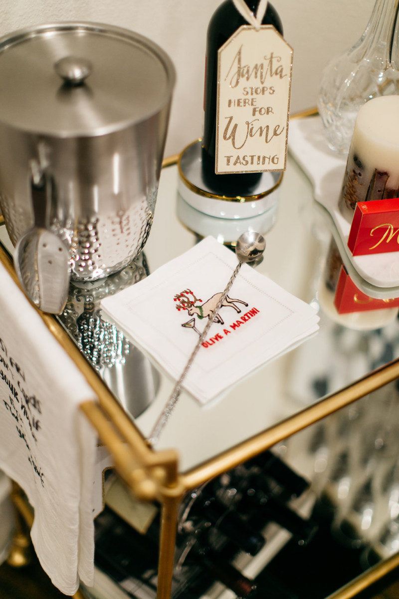 A gold bar cart with Christmas drink decor