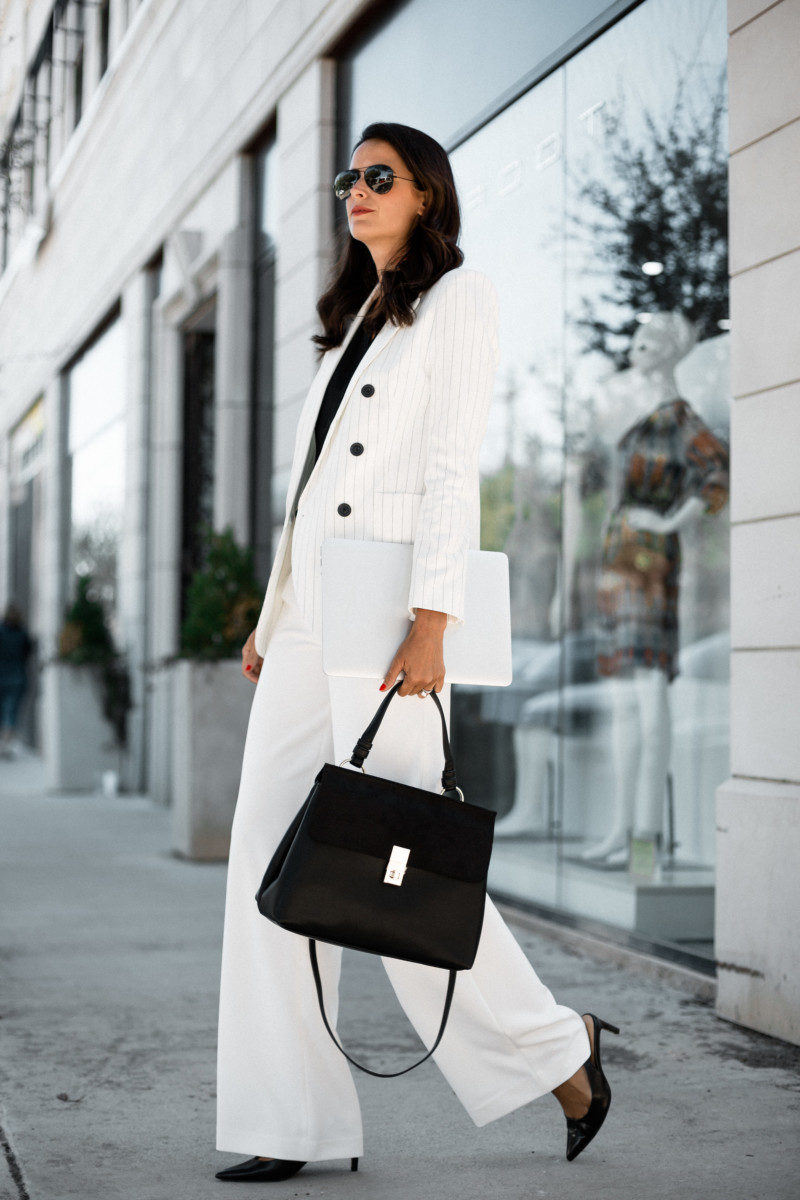 The Miller Affect wearing a white suit with black slingback pumps