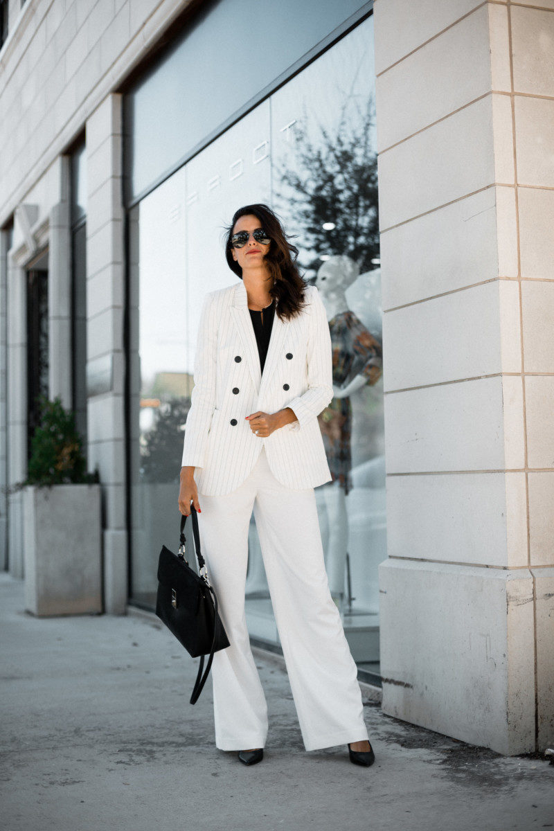 The Miller Affect wearing a white pantsuit from Express