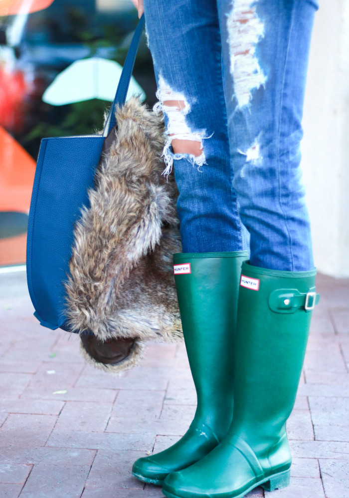 fur vest, green hunter boots, distressed denim