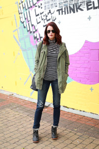 green cargo jacket, striped turtleneck, distressed jeans, black duck boots