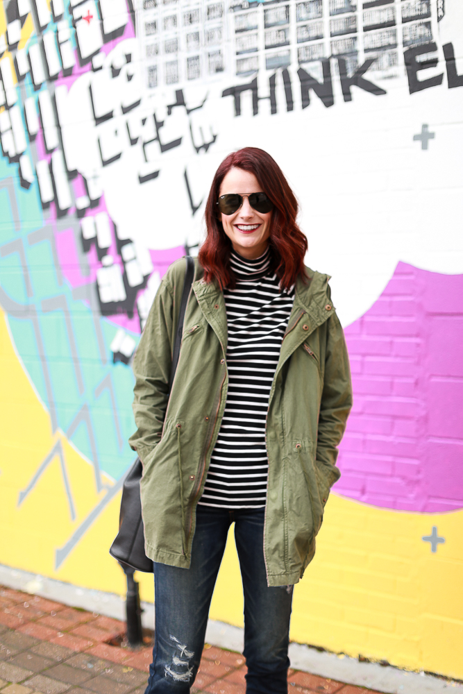 redhead, green cargo jacket, striped turtleneck, distressed jeans, black duck boots