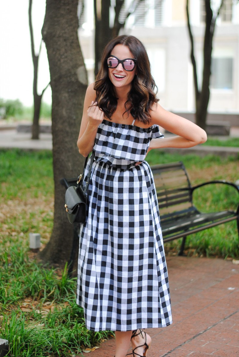 Amanda Miller wearing pink mirrored sunglasses and a off the shoulder gingham dress