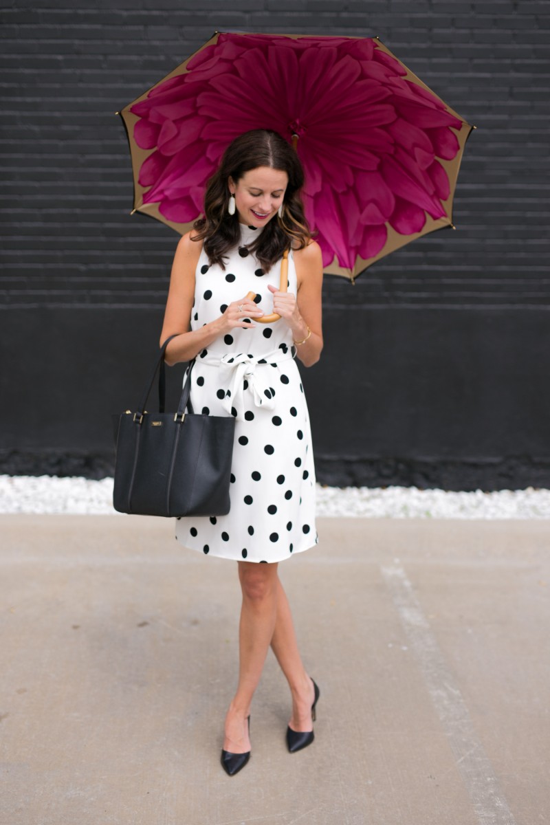 The Miller Affect holding a floral Brellini umbrella and wearing a polka dot dress
