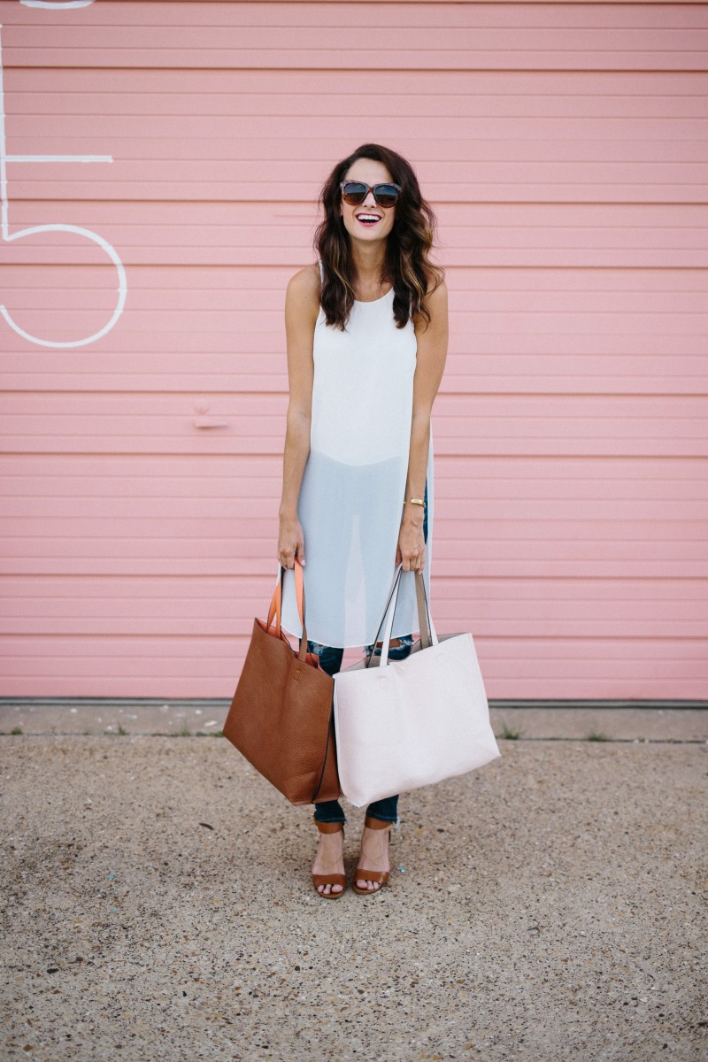 Amanda Miller holding a cognac reversible tote and a light pink reversible tote
