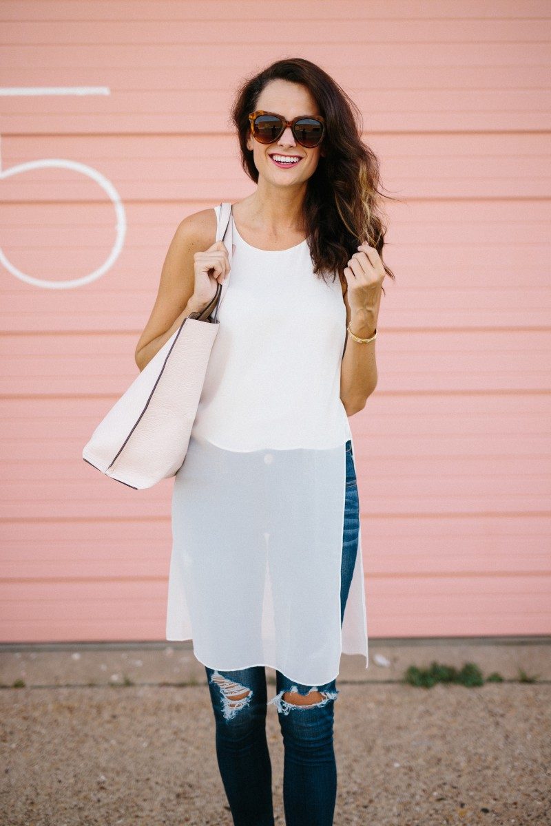 Amanda Miller carrying a pink reversible tote and a white chiffon top