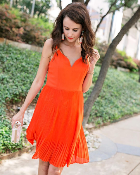 The Miller Affect wearing the prettiest coral pleated dress - under $100
