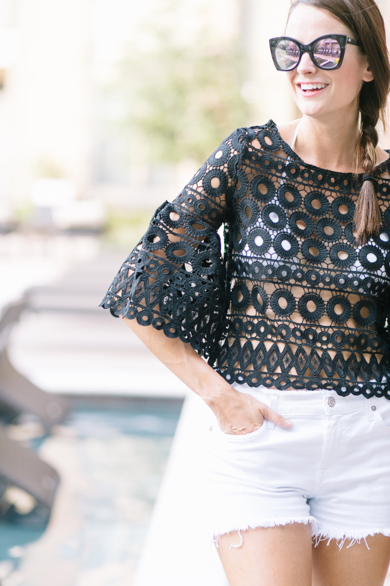 Amanda Miller wearing a bell-sleeved black crochet top to a pool party