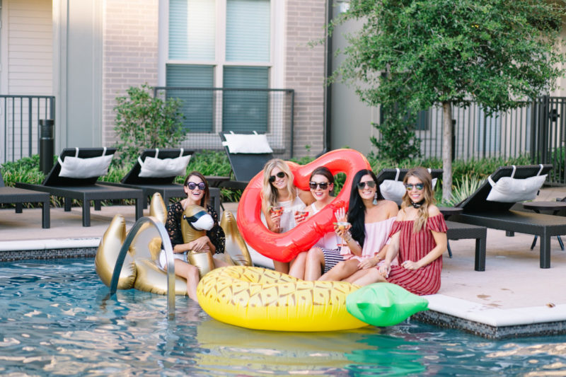 The Miller Affect and friends holding pool floats for a pool party