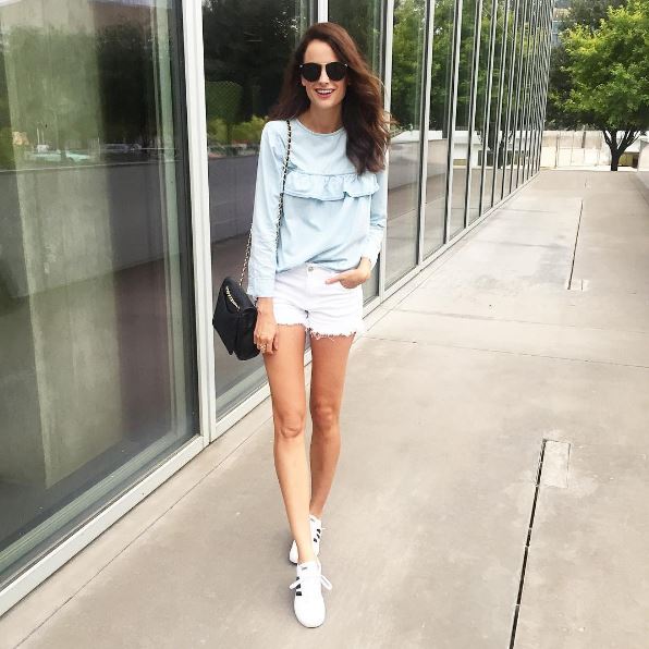 The Miller Affect in a chambray ruffled top and adidas sneakers