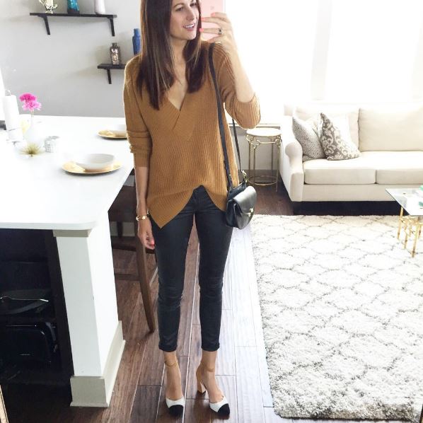 The Miller Affect wearing a camel oversized sweater, leather leggings, and colorblock heels