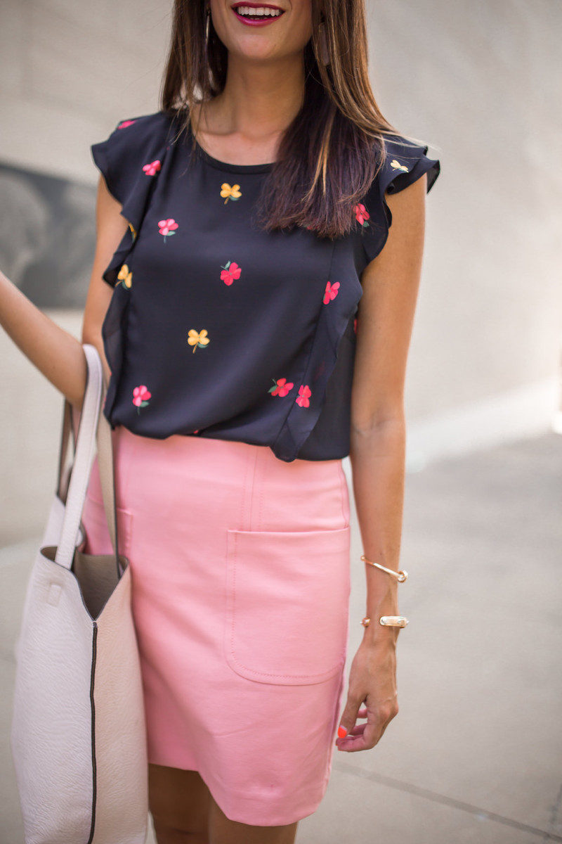 The Miller Affect talking about Dallas Community Colleges in a pink skirt and flutter sleeve top