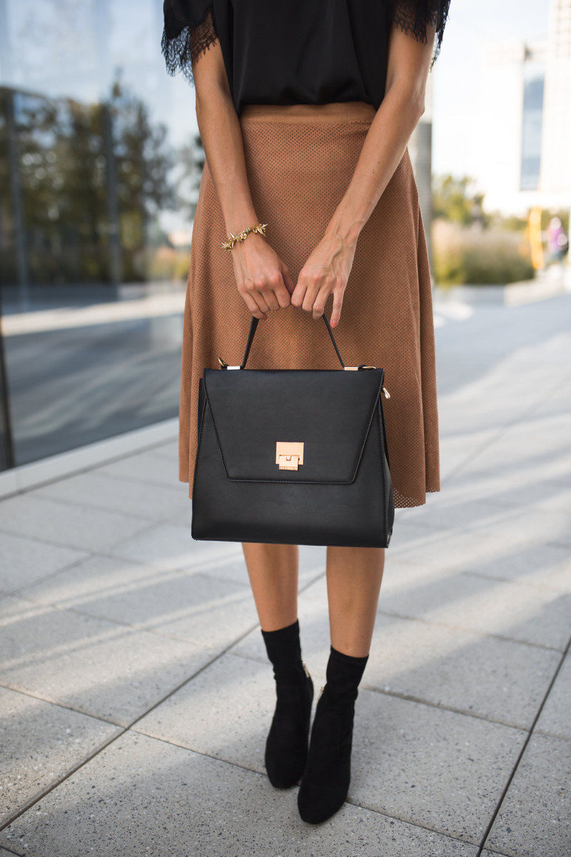 The Miller Affect carrying a black structured handbag from The Styled Collection