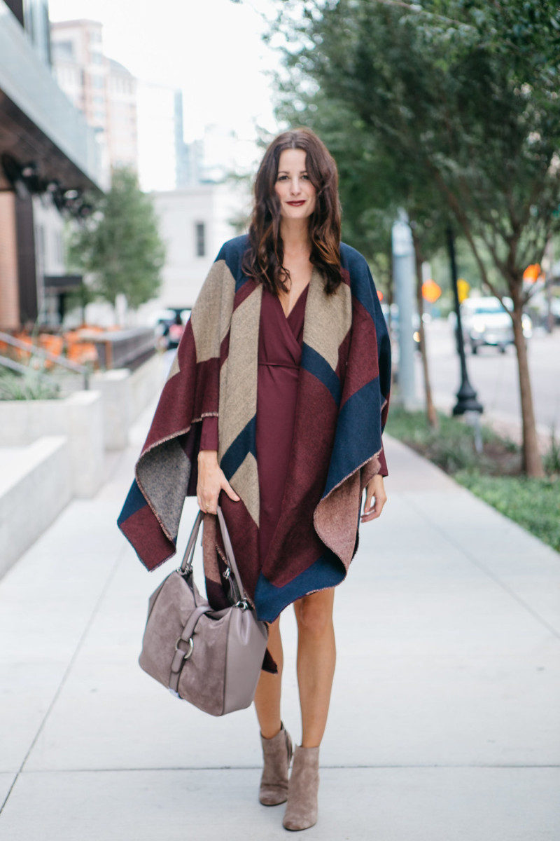 The Miller Affect wearing a colorblock poncho and a suede handbag