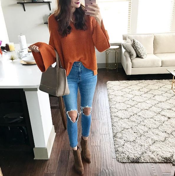 The Miller Affect wearing an orange bell-sleeved sweater with a nude Botkier handbag