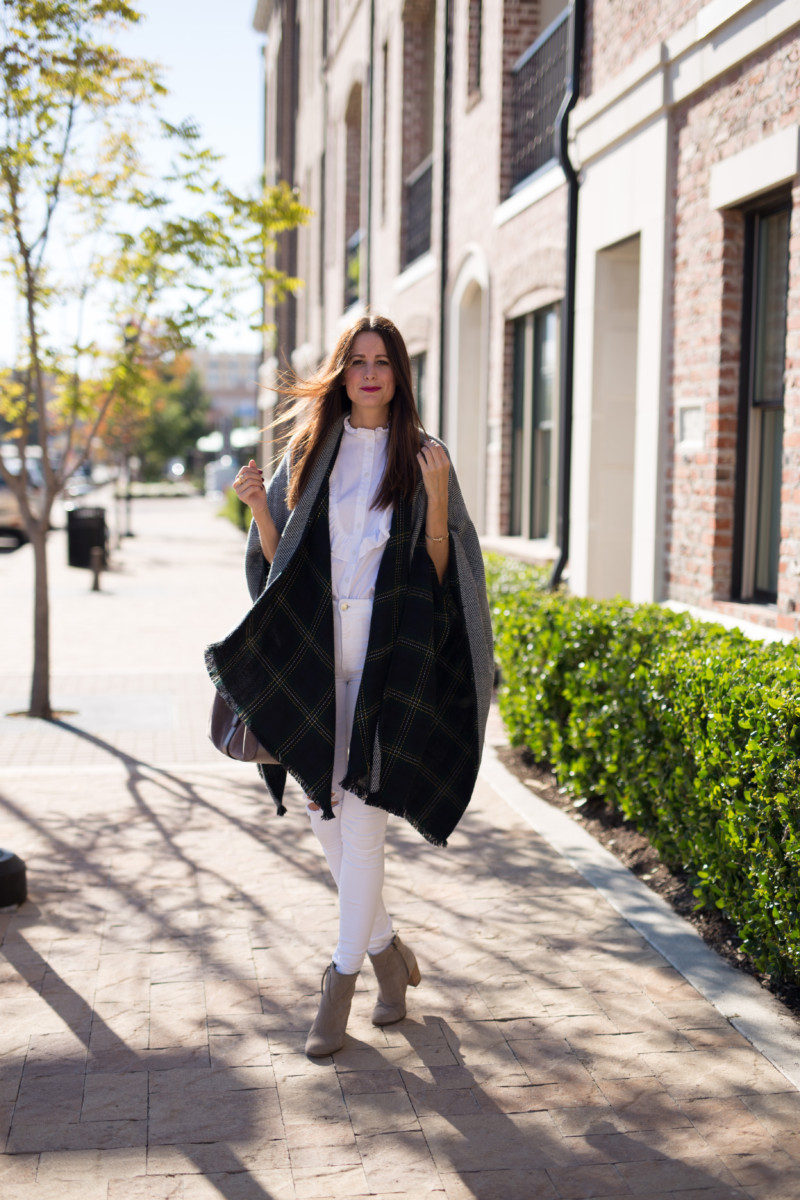 The Miller Affect wearing a plaid and herringbone reversible cape under $50