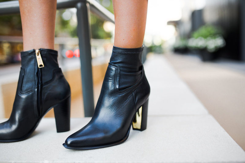 The Miller Affect wearing black leather boots with gold heels from Rachel Zoe