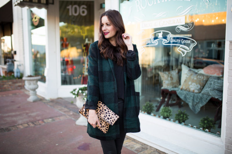 The Miller Affect wearing a buffalo plaid green and black coat