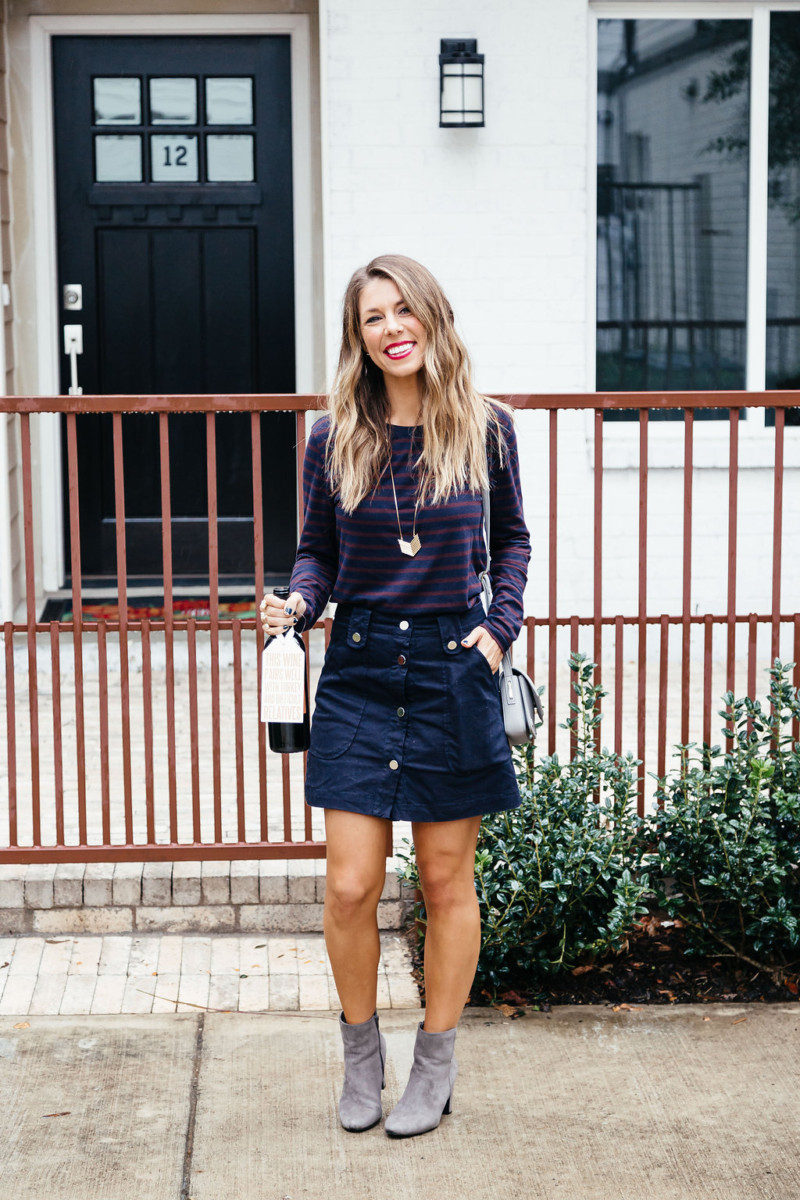 The Fashion Hour in a striped top, navy button up skirt, and grey booties for Thanksgiving