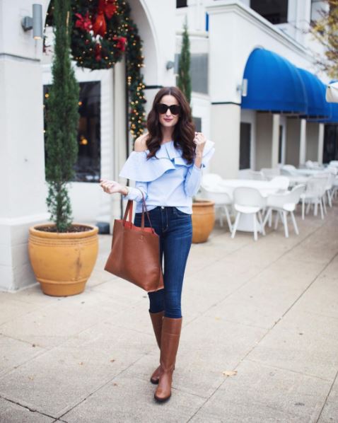 The Miller Affect wearing a one shoulder ruffle top from Shopbop, leather tory burch riding boots currently on sale, and tortoise cat eye sunglasses