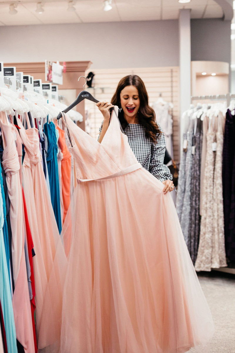 The Miller Affect holding up a pink tulle bridesmaid dress