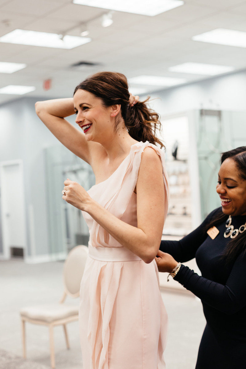 The Miller Affect trying on a light pink Vera Wang bridesmaid dress from David's Bridal