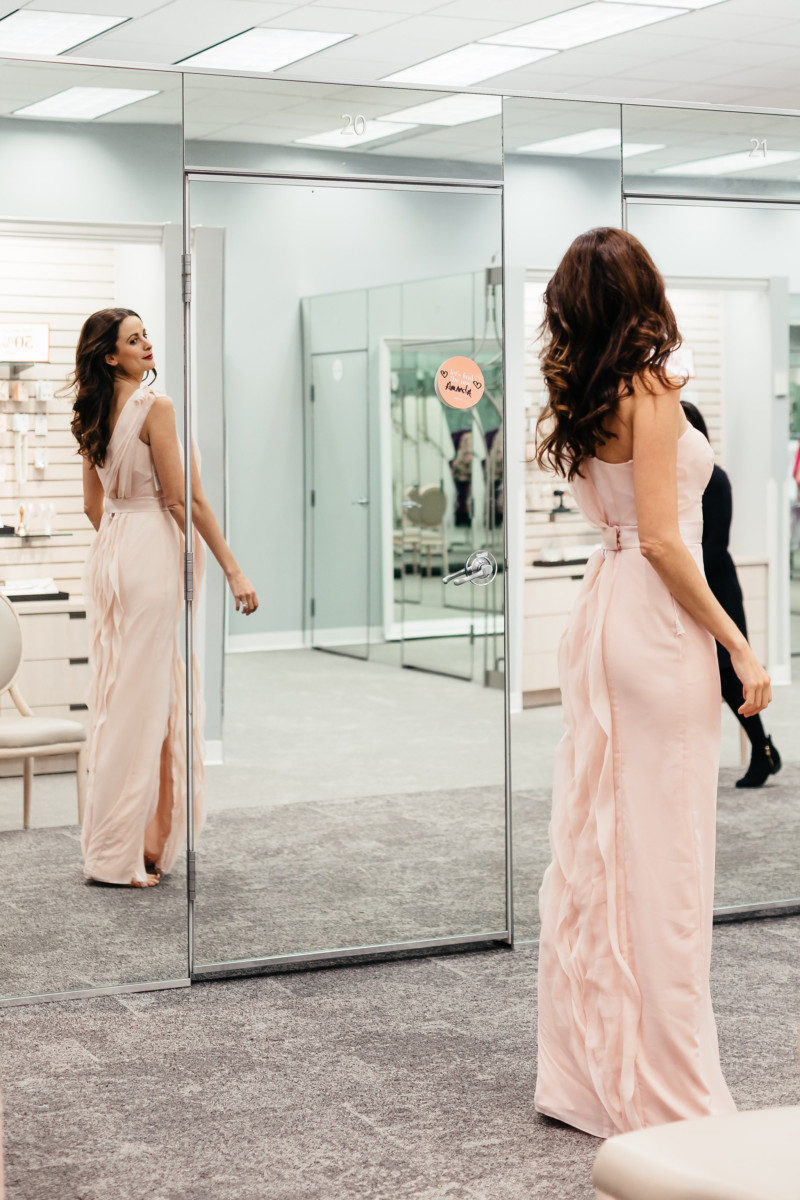 The Miller Affect trying on a light pink Vera Wang bridesmaid dress from David's Bridal