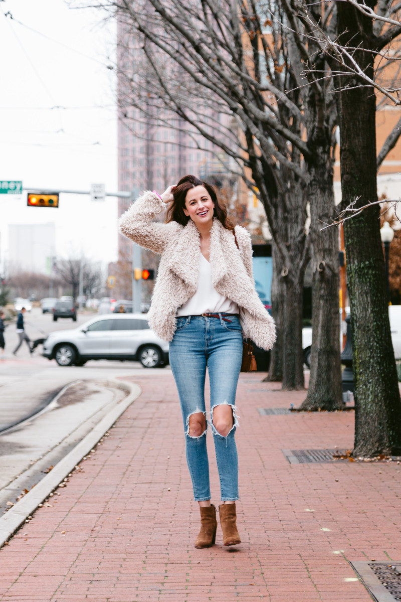 The Miller Affect wearing a fuzzy jacket with distressed jeans and brown suede booties