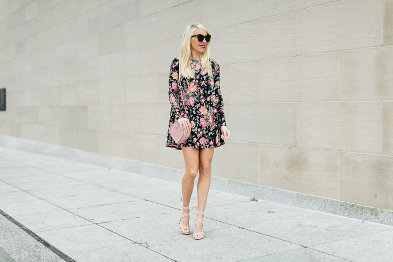 Jaime Shrayber wearing a floral swing dress and heart purse for Valentine's Day