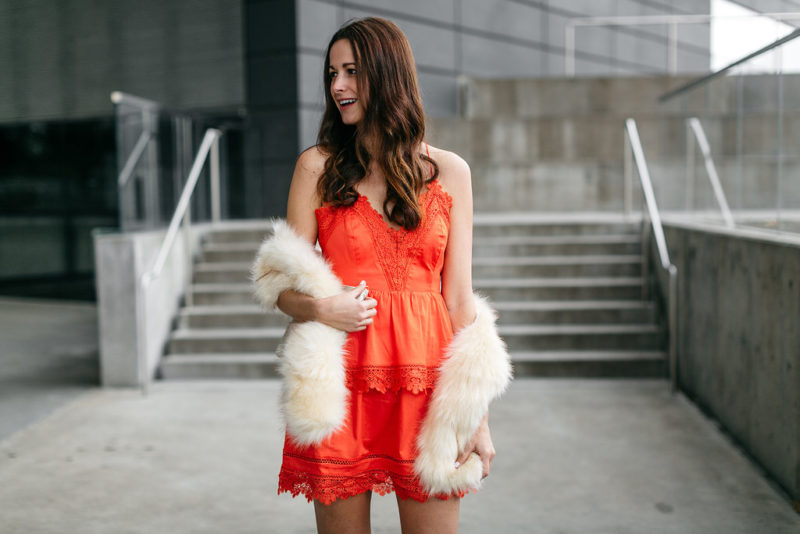 Amanda Miller wearing an orange lace dress from Bardot