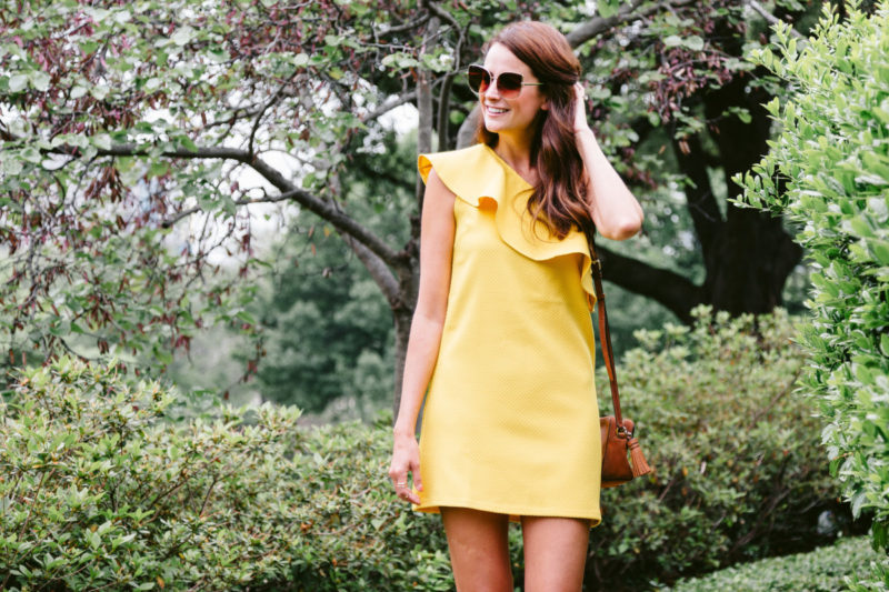 The Miller Affect wearing a yellow one shoulder dress