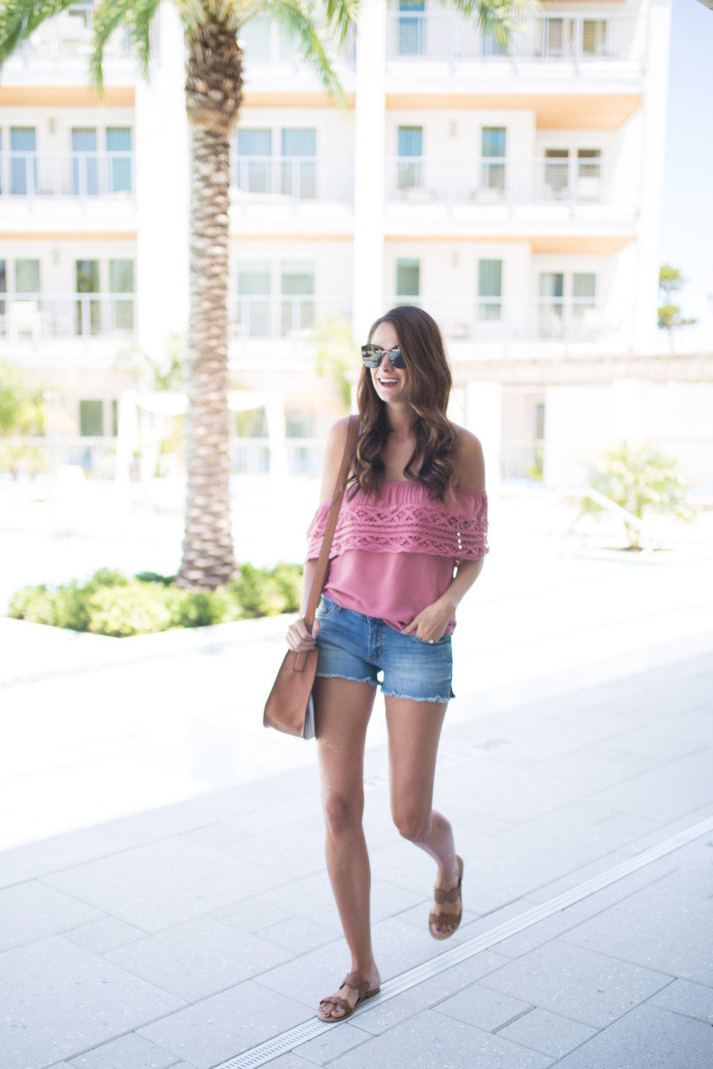 The Miller Affect wearing jean shorts and an off the shoulder top under $50