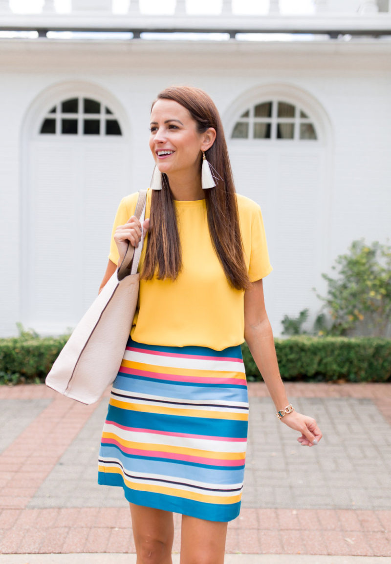 The Miller Affect wearing ivory tassel earrings and a bright work wear post from LOFT