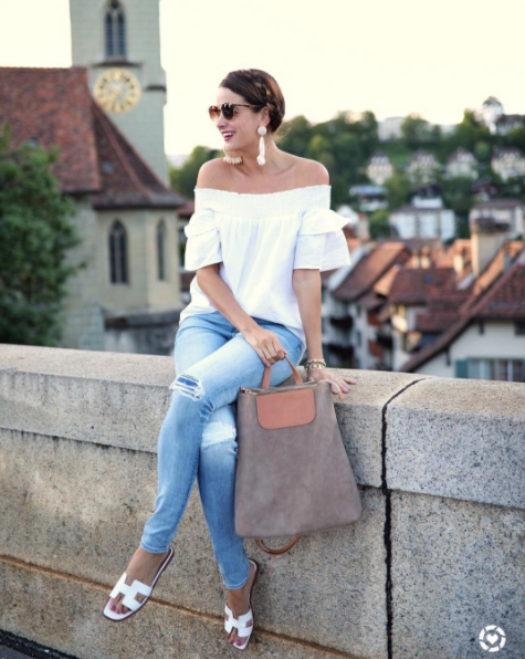 The Miller Affect wearing a white off the shoulder top in Bern Switzerland