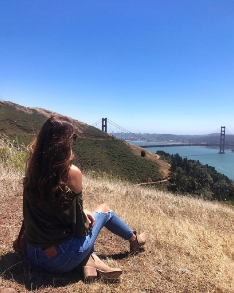 the miller affect wearing a free people moss off the shoulder top at the Golden Gate Bridge