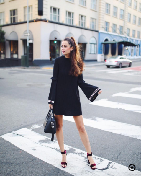 The Miller Affect wearing a black sweater dress from Free People with Bell Sleeves