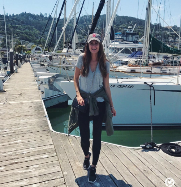the miller affect in Sausalito wearing black leggings, an olive cargo jacket, and a grey v neck top