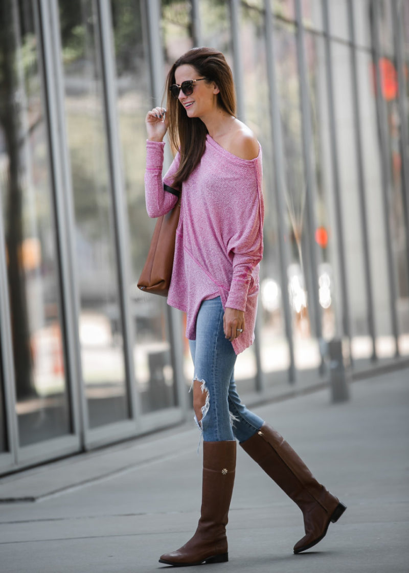 The Miller Affect wearing brown riding boots with a pink free people top