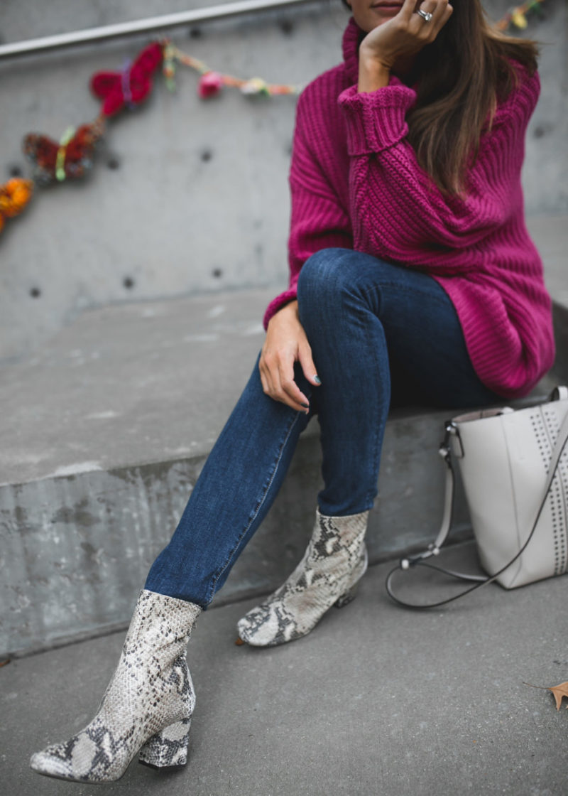 The Miller affect wearing a hot pink chunky sweater from Free People