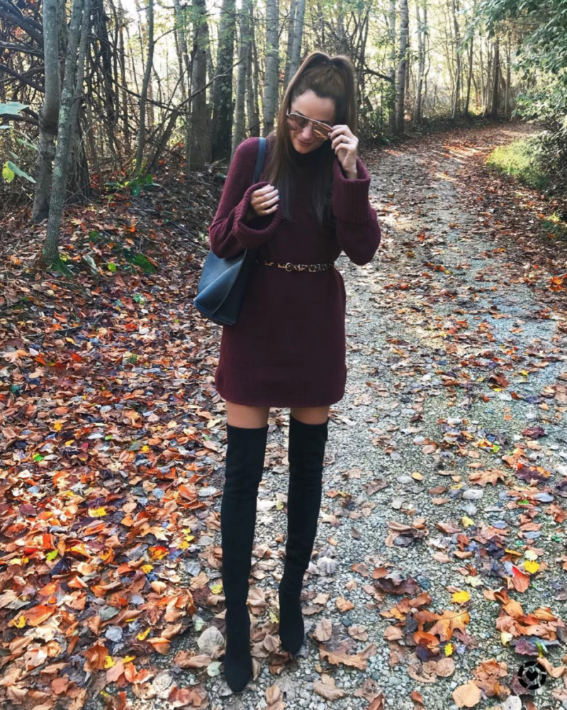 the miller affect wearing a maroon sweater dress with a ribbed cuff