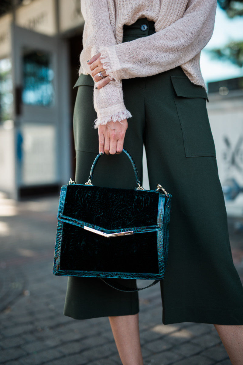 the miller affect carrying a green velvet brahmin handbag