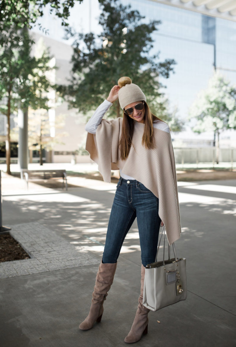 the miller affect wearing a henri bendel t cape and faux fur beanie