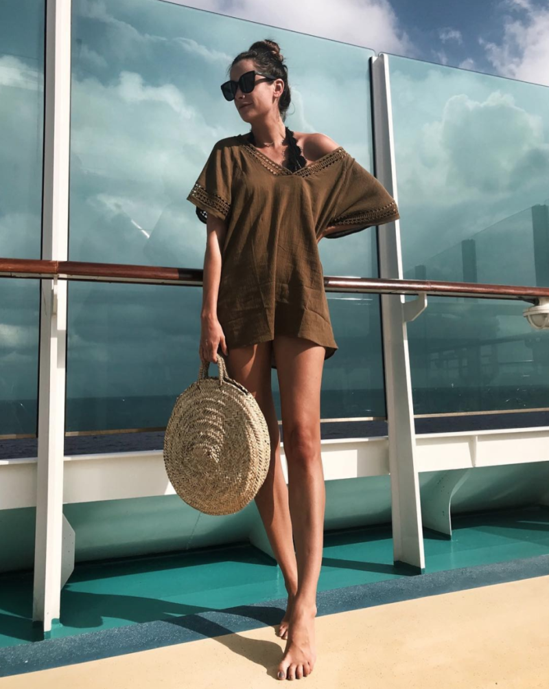 the miller affect wearing a pily q lace swimsuit with an olive cover-up