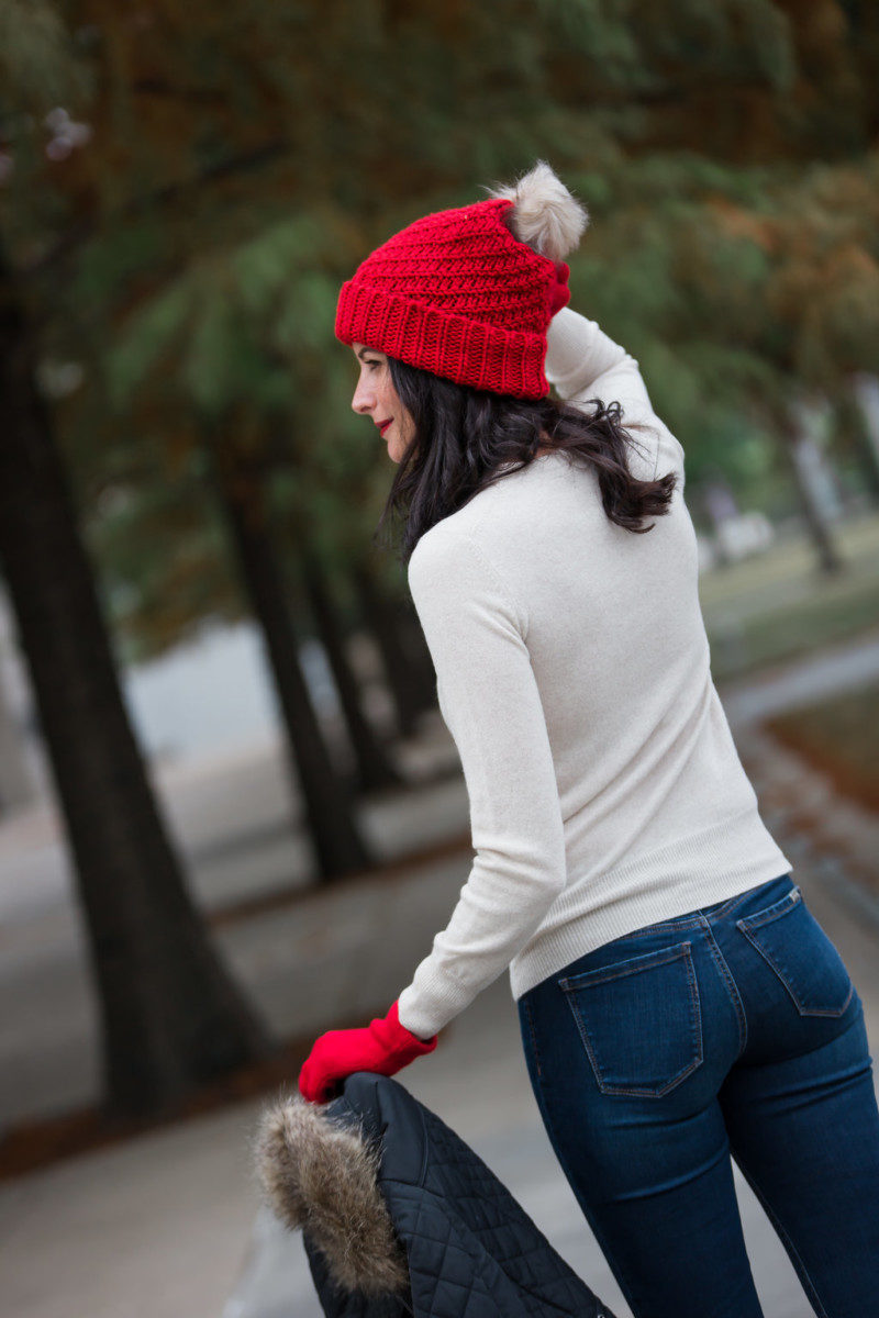 The Miller Affect wearing a red fur pom knit beanie with red gloves