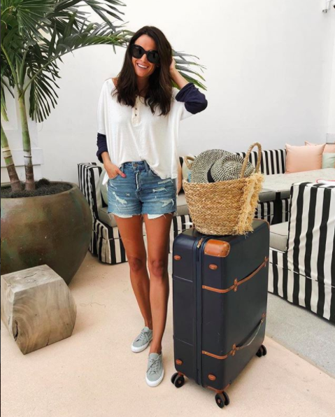 the miller affect wearing a free people baseball tee with bric's luggage