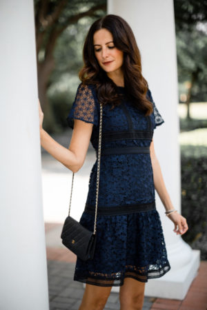 the miller affect wearing a navy lace dress to a summer wedding